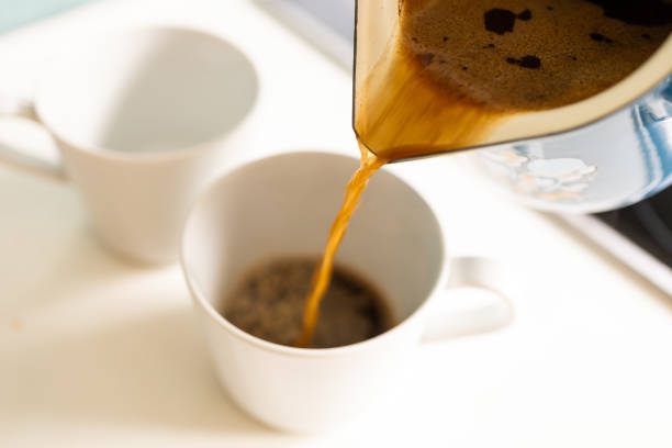 Delicately, freshly brewed coffee is poured from the pot into a waiting mug. The rich aroma wafts upwards, tantalizing the senses with its promise of warmth and flavor. As the coffee fills the mug, anticipation builds for the first invigorating sip of the day.