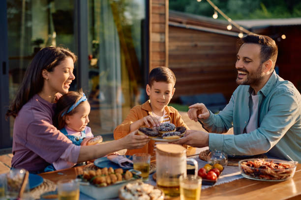 istock Happy family having dessert while eating at dining table on a patio. 2151088955