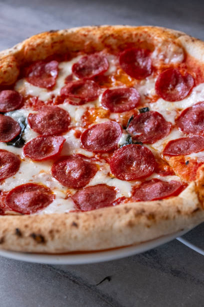 istock italian pizza in oven on rotating 2151089294