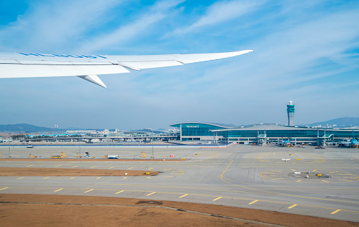 Incheon, S. Korea - Nov 27, 2019: Airplane lifted off from the runway tarmac at Incheon International Airport, Terminal 2. View from inside the passenger cabin.