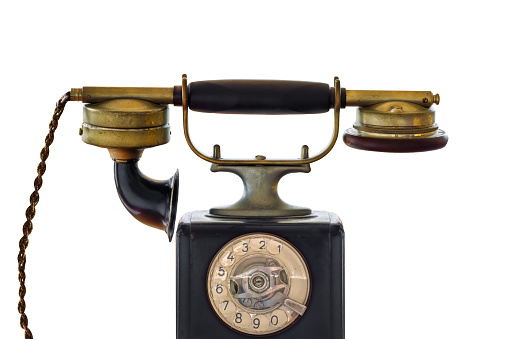 Early twentieth century black telephone isolated on a white background