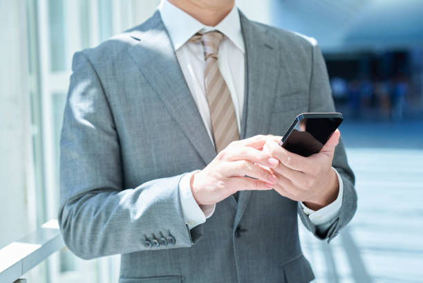 istock Hand of a businessman operating a smartphone 2151090352