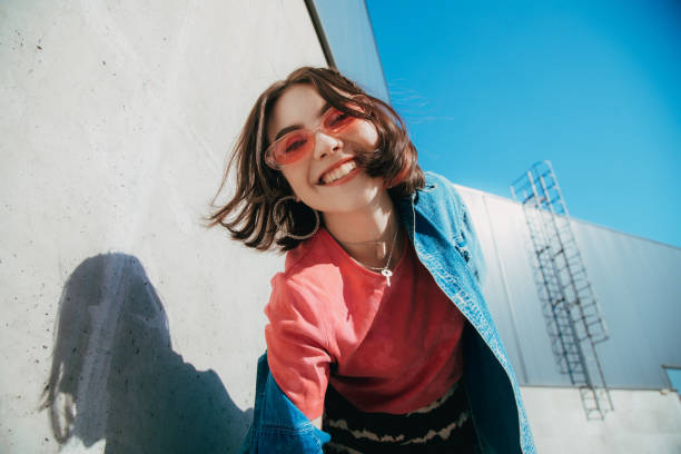 istock Female looking at the camera with wide smile while walking 2151090408