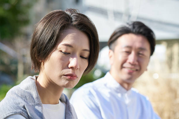istock A woman looking unhappy next to a man 2151092302