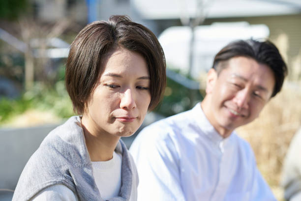 istock A woman looking unhappy next to a man 2151092335