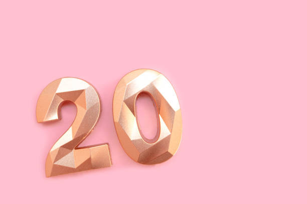 istock Gold colored number twenty on a pink background. 2151093533