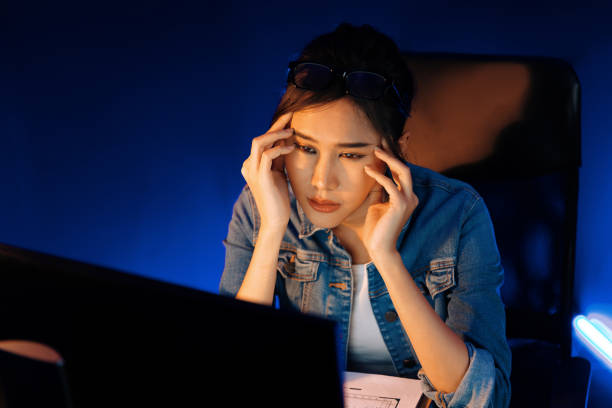 istock Stressful asian creative looking on pc to search project creator. Stratagem. 2151093540