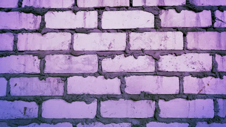 Grunge brick wall with pink lighting