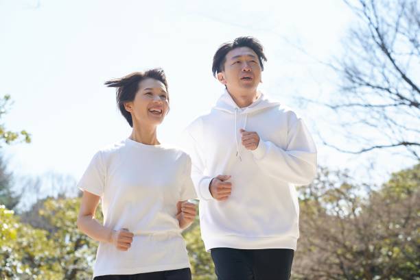 istock Man and woman running side by side 2151093938