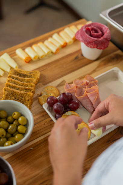 istock The beautiful chef prepares a cheese board from her home kitchen 2151094952