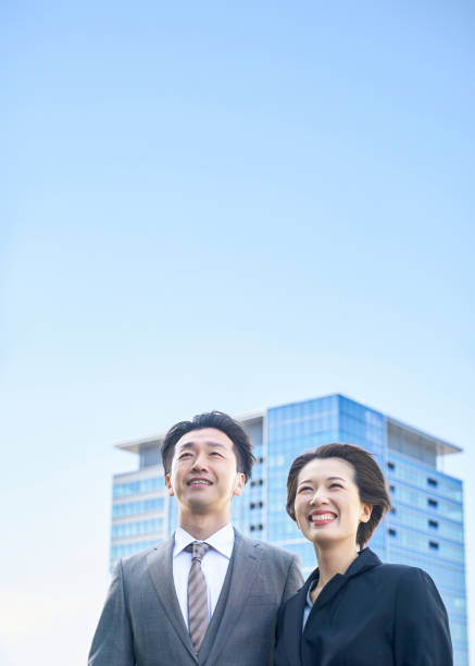 istock Man and woman in suits and modern architecture 2151095396