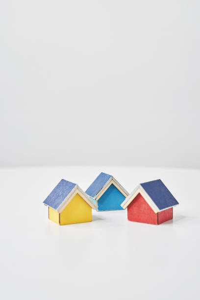 istock Models of houses lined up on a white table 2151096086