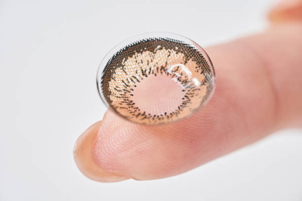 istock Woman's fingers with colored contact lenses 2151096276