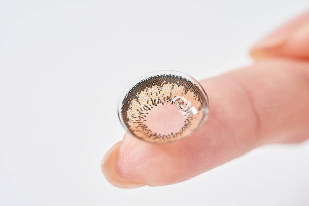 istock Woman's fingers with colored contact lenses 2151096300