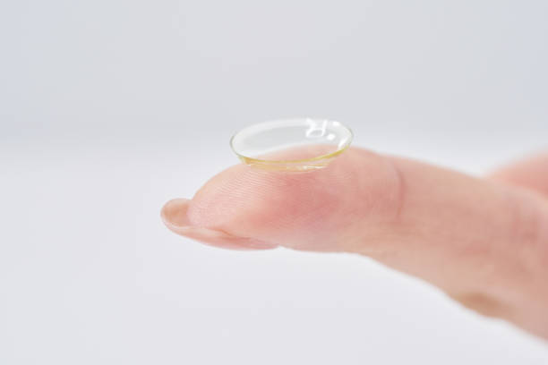 istock woman's fingers with contact lenses 2151096325