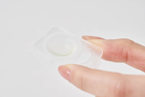 istock woman's fingers with contact lenses 2151096338