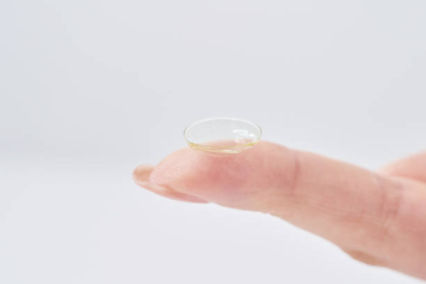 istock woman's fingers with contact lenses 2151096377
