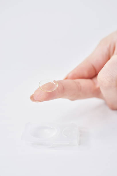 istock woman's fingers with contact lenses 2151096408