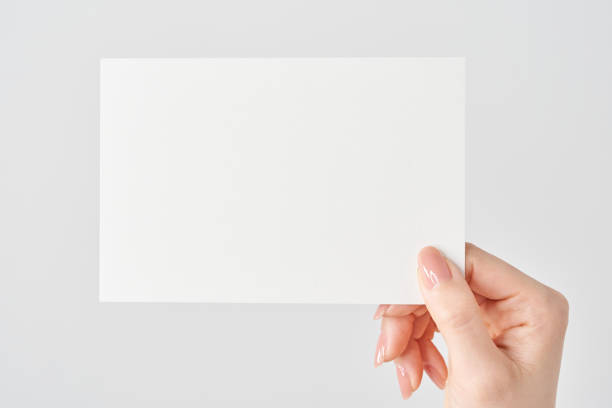 Woman's hand holding white paper