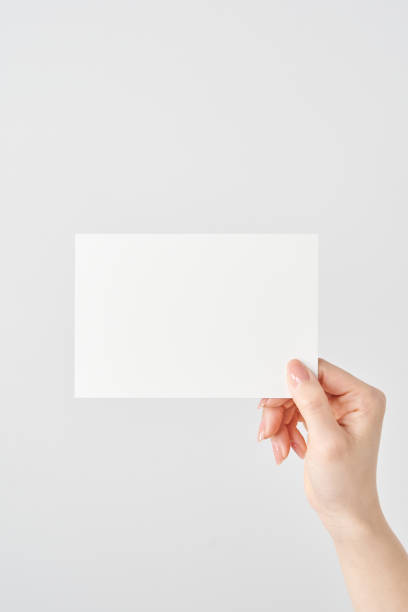 istock Woman's hand holding white paper 2151096539