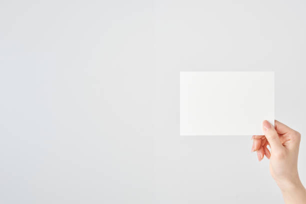 istock Woman's hand holding white paper 2151096542