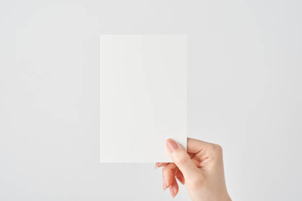 istock Woman's hand holding white paper 2151096564