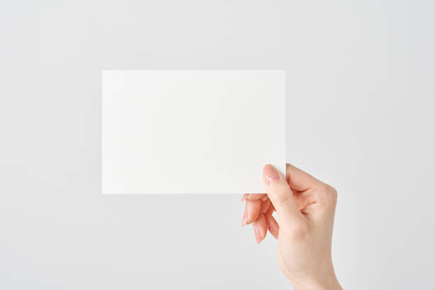 istock Woman's hand holding white paper 2151096567