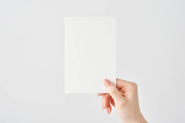 istock Woman's hand holding white paper 2151096585