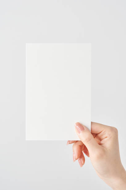 istock Woman's hand holding white paper 2151097075