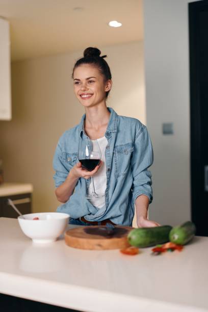 istock Happy, Attractive Young Female Enjoying a Delicious Breakfast in a Modern Kitchen 2151103021