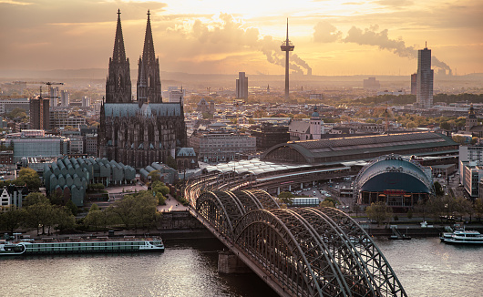 Ariel view of Cologne Cathedral, Rhine river, Cologne central station and Hohenzollern Bridge at sunset, travel background