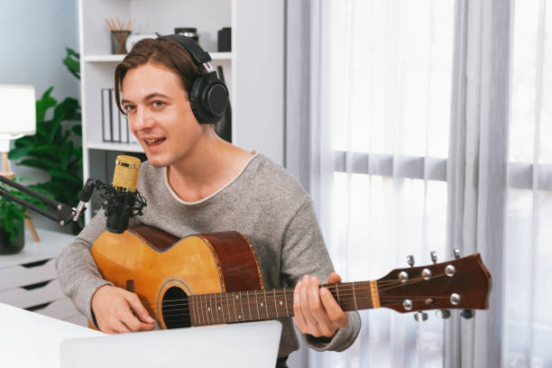 istock Singer with smile face on social media, playing guitar along singing. Pecuniary. 2151104397