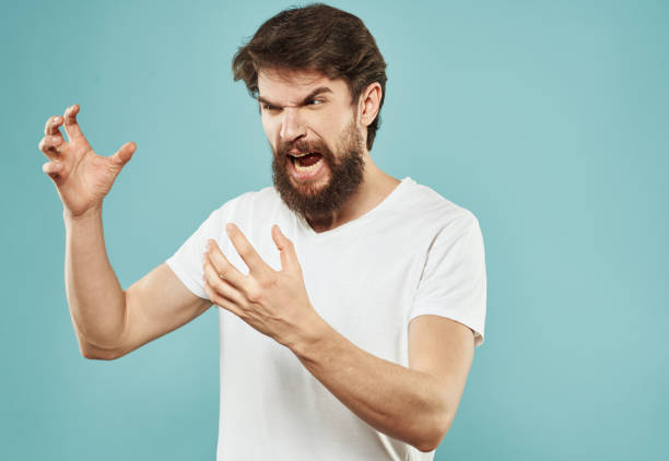 istock emotional man with beard on blue background gesturing with hands cropped view Copy Space 2151108725