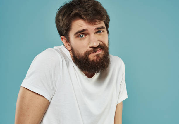 upset man on blue background cropped view Copy Space Model. High quality photo