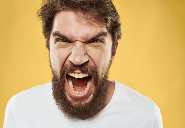 istock irritable young man with beard on yellow background cropped view 2151109161