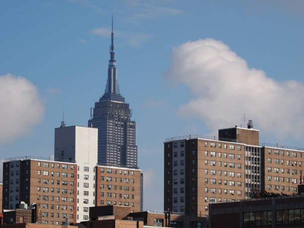 New York, USA - January 1, 2024: Image of theNew York, USA - January 1, 2024: Image of the Empire State Building with some apartment buildings in the foreground.