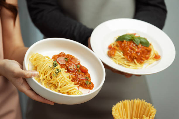 istock Close up hand couple chef influencers completely cooked spaghetti. Postulate. 2151109624