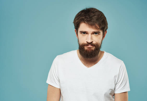 istock Upset man on blue background emotions model sadness cropped view 2151109895