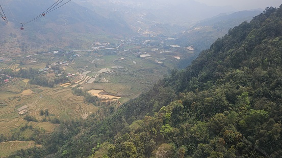 Aerial view of forest, mountain and traditional houses at Fansipan mountain, Sa Pa town, Vietnam.