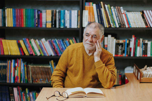 istock Lifelong Learning Front View of Senior Man Immersed in Reading 2151110725