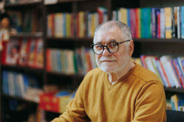 istock Bookish Haven Front View of Wise Elderly Man in Bookstore 2151110748