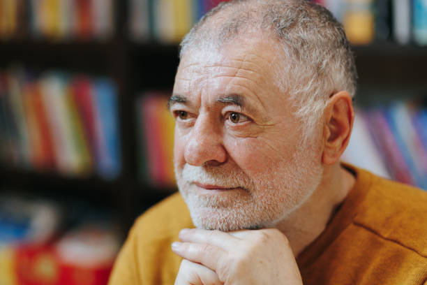 istock Library Legacy Front View of Wise Elderly Man Surrounded by Books 2151110762