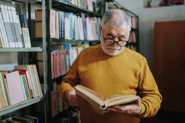 istock Literary Sanctuary An Old Man Immersed in Reading 2151110782