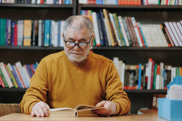 istock Bookish Delight A Senior Man Engrossed in Reading 2151110794