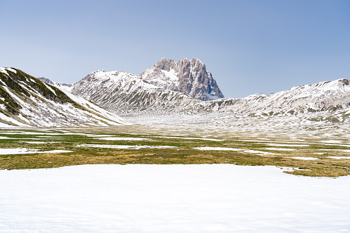 Pasture in front of snow covered Corno Grande in Gran Sasso National Park