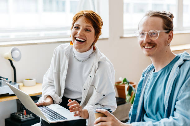 istock Smiling colleagues working together in a bright co-working space 2151116281