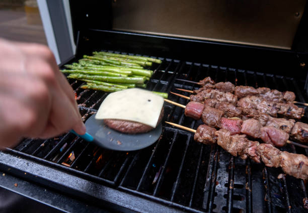 man is making grill barbecue outdoors on the backyard. Bbq party.