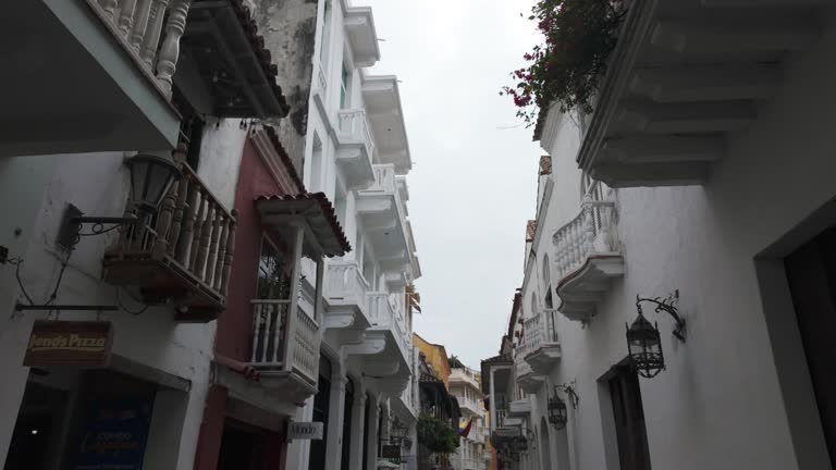Overhanging balconies line a quiet street in Cartagena's historic heart, Colombia