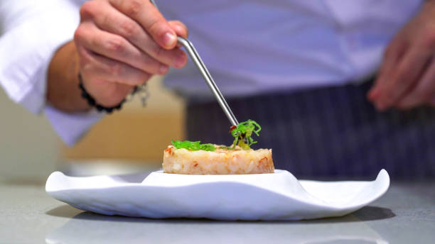 istock Professional chef cooking in domestic kitchen: Gamberoni prawns tartare final decoration, goma wakame 2151120708