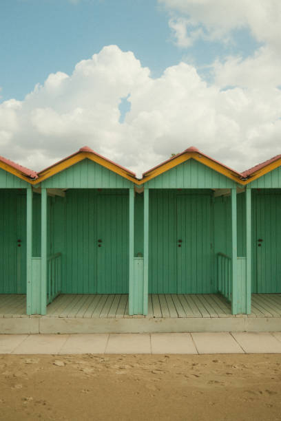 Green cabins on the beach at the sea. Vintage look.
